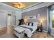 Comfortable main bedroom with accent walls, wood flooring and large windows for ample light at 13136 Peregrin Cir, Bradenton, FL 34212