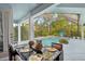 Elegant outdoor dining area with a screened-in pool view at 13136 Peregrin Cir, Bradenton, FL 34212
