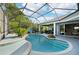 Gorgeous swimming pool with connected hot tub and lush landscaping at 13136 Peregrin Cir, Bradenton, FL 34212