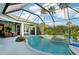 Relaxing screened pool with spa, complete with a basketball hoop and lush landscaping, perfect for outdoor enjoyment at 13136 Peregrin Cir, Bradenton, FL 34212