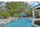 Private screened-in pool area with spa, basketball hoop, tropical landscaping and a relaxing backyard at 13136 Peregrin Cir, Bradenton, FL 34212