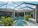 Aerial view of backyard pool and hot tub featuring screened in porch at 13136 Peregrin Cir, Bradenton, FL 34212