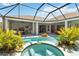 Inviting pool area with an attached spa, lush landscaping, and an outdoor seating area at 13136 Peregrin Cir, Bradenton, FL 34212