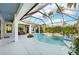 Relaxing screened pool with spa, complete with a basketball hoop and lush landscaping, perfect for outdoor enjoyment at 13136 Peregrin Cir, Bradenton, FL 34212