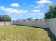 Spacious backyard featuring a well-maintained lawn and a white privacy fence perfect for outdoor enjoyment at 15452 Long Cypress Dr, Ruskin, FL 33573
