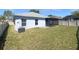Expansive backyard with a lush green lawn and screened-in patio perfect for outdoor enjoyment at 15452 Long Cypress Dr, Ruskin, FL 33573