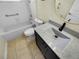 Updated bathroom features a shower, tub, toilet, and vanity with granite countertop at 15452 Long Cypress Dr, Ruskin, FL 33573