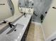 Beautiful bathroom featuring double sinks, a modern vanity, and a walk-in shower at 15452 Long Cypress Dr, Ruskin, FL 33573