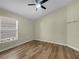 Well-lit bedroom with wood flooring, featuring a window that brings in natural light at 15452 Long Cypress Dr, Ruskin, FL 33573