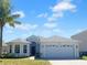 Charming single-Gathering home featuring a well-manicured lawn and a two-car garage at 15452 Long Cypress Dr, Ruskin, FL 33573