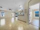 Open living room featuring tile flooring and access to kitchen, dining, and patio areas at 15452 Long Cypress Dr, Ruskin, FL 33573
