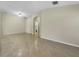 Spacious living room with tile flooring and neutral walls, offering a versatile living space at 15452 Long Cypress Dr, Ruskin, FL 33573
