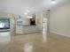 Open floor plan with tile flooring and a spacious living area leading to the kitchen at 15452 Long Cypress Dr, Ruskin, FL 33573