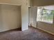 View of a bedroom with an open closet, and a window, showcasing space for a comfortable living area at 2918 E Waters Ave, Tampa, FL 33604