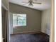 Bedroom with a ceiling fan and closet, featuring an exterior view through a window, ideal for customization at 2918 E Waters Ave, Tampa, FL 33604