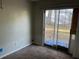 Bedroom featuring sliding glass door to the backyard and neutral-toned carpeting at 2918 E Waters Ave, Tampa, FL 33604