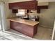 Kitchen featuring dark wood cabinets and a breakfast bar area at 2918 E Waters Ave, Tampa, FL 33604
