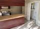 View of a kitchen featuring upper cabinets and an adjacent water heater closet at 2918 E Waters Ave, Tampa, FL 33604