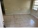 Spacious living room with neutral tile floors and natural light from a large window at 2918 E Waters Ave, Tampa, FL 33604
