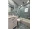 Stylish bathroom featuring hexagon tiles, frameless shower doors, and modern vanity at 3747 Floramar Ter, New Port Richey, FL 34652