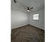 This bedroom features a ceiling fan, large window, and updated flooring at 3747 Floramar Ter, New Port Richey, FL 34652
