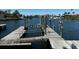 Wooden dock with boat lift providing direct access to the waterfront at 3747 Floramar Ter, New Port Richey, FL 34652