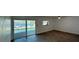 Spacious living room features herringbone floors and large windows overlooking the waterfront at 3747 Floramar Ter, New Port Richey, FL 34652