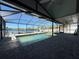 Enclosed pool area offering waterfront views and ample patio space for outdoor relaxation at 3747 Floramar Ter, New Port Richey, FL 34652