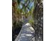 Gated entrance to walkway with pavers and mature landscaping at 3747 Floramar Ter, New Port Richey, FL 34652