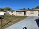 Charming single-story home with a well-maintained lawn and a concrete driveway leading to the entrance at 3522 Windham Dr, Holiday, FL 34691