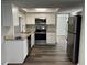 Modern kitchen with stainless steel appliances, granite countertops, and white cabinets, perfect for culinary enthusiasts at 3522 Windham Dr, Holiday, FL 34691