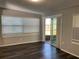 Bright, airy living room featuring dark floors, ample natural light, and a sliding glass door to the outside at 3522 Windham Dr, Holiday, FL 34691
