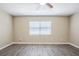 Cozy bedroom with neutral walls, window with blinds, and attractive gray wood-look flooring at 3645 6Th S St, St Petersburg, FL 33705
