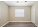 Bedroom featuring neutral walls, a window with blinds, and modern gray wood-look flooring at 3645 6Th S St, St Petersburg, FL 33705