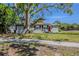 Charming single-story home with a red door and lush green lawn in a quiet neighborhood at 3645 6Th S St, St Petersburg, FL 33705
