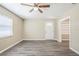 Inviting living room featuring neutral walls, stylish gray wood-look flooring, and a window at 3645 6Th S St, St Petersburg, FL 33705