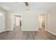 Spacious living room showcasing neutral walls, stylish gray wood-look flooring, and multiple doorways at 3645 6Th S St, St Petersburg, FL 33705