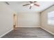 Bright living room featuring neutral walls, modern ceiling fan, and stylish gray wood-look flooring at 3645 6Th S St, St Petersburg, FL 33705