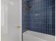 Modern bathroom featuring a bathtub with blue tile, and gold hardware at 7338 N Ficus Tree, Punta Gorda, FL 33955