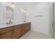 Modern bathroom features a wood vanity with double sinks, tile backsplash, and a glass enclosed shower at 7338 N Ficus Tree, Punta Gorda, FL 33955