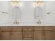 Modern bathroom boasts a wood vanity with double sinks and gold hardware at 7338 N Ficus Tree, Punta Gorda, FL 33955