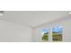 Light bedroom features recessed lighting, white walls, baseboards and windows looking out to trees at 7338 N Ficus Tree, Punta Gorda, FL 33955