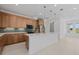 Modern kitchen with stainless steel appliances, granite countertops, a large island, and decorative pendant lights at 7338 N Ficus Tree, Punta Gorda, FL 33955