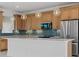 Modern kitchen featuring a large island, wooden cabinetry, stainless steel appliances, and pendant lighting at 7338 N Ficus Tree, Punta Gorda, FL 33955