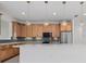 Modern kitchen with stainless steel appliances, granite countertops, a large island, and decorative pendant lights at 7338 N Ficus Tree, Punta Gorda, FL 33955