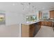Bright kitchen with a spacious island, wood cabinets, stainless steel appliances, and sliding glass doors at 7338 N Ficus Tree, Punta Gorda, FL 33955