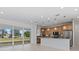 Bright open-concept living space featuring a modern kitchen and large glass doors leading to an outdoor view at 7338 N Ficus Tree, Punta Gorda, FL 33955