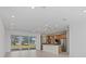 Bright open-concept living space featuring a modern kitchen and large glass doors leading to an outdoor view at 7338 N Ficus Tree, Punta Gorda, FL 33955