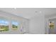 Bright room featuring tiled floors, large windows, and glass doors that provide ample natural light at 7338 N Ficus Tree, Punta Gorda, FL 33955