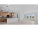 Bright open-concept living space featuring a modern kitchen, natural light, and tiled floors at 7338 N Ficus Tree, Punta Gorda, FL 33955